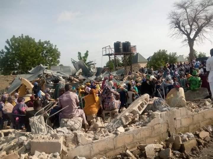 Church members worship in the rubble after demolition