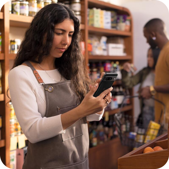 Woman in a shop working on her Pixel phone.