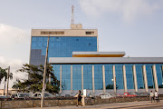 Pedestrians walk in front of GCB Bank, the country's leading commercial bank, in Accra, Ghana. File photo.