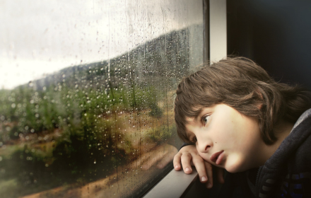 The boy watched the rain by the window small promo image