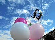 Balloons with an image of 28-year-old Tshegofatso Pule float in the air at her funeral. Pule, who  was eight months pregnant, was found stabbed and hanging from a tree.