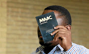 The pastor accused of rape hides his face  in the dock at Soshanguve magistrate's court, ironically using material by an organisation opposed to abuse in churches.  His alleged victims were   boys.  / SANDILE NDLOVU