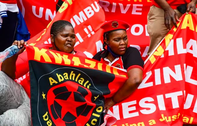 Members of shack-dwellers movement, Abahlali baseMjondolo protest the alleged theft of Covid-19 funds in Durban.