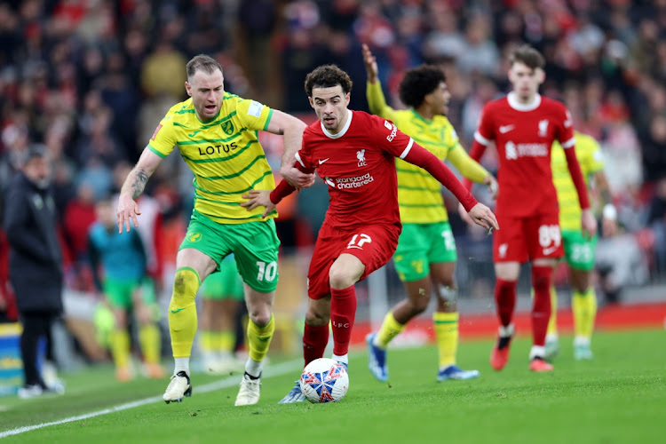 Curtis Jones of Liverpool and Ashley Barnes of Norwich City battle for the ball during the match between Liverpool and Norwich City at Anfield in Liverpool, England, on Sunday. Picture: Getty Images/Clive Brunskill