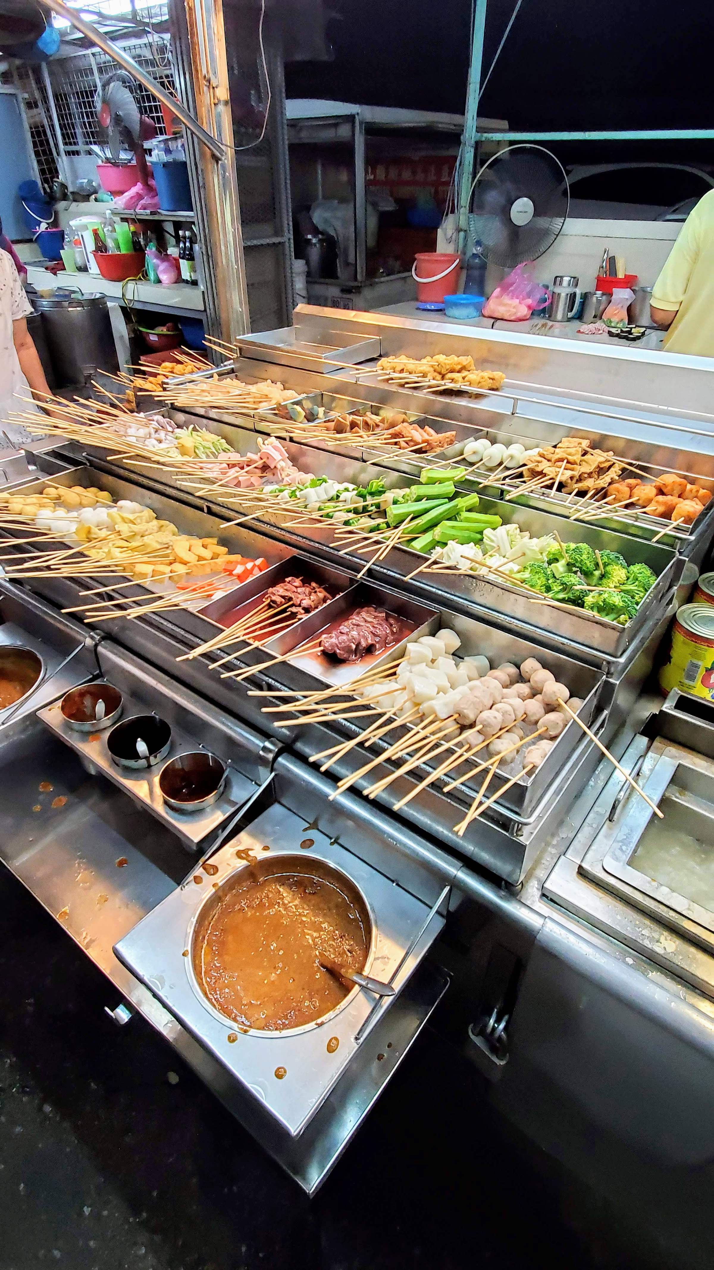 Something a little bit more unique you'll find in the evening is Lok Lok. This is  a stand where everything is on a skewer, and you can grab whatever you want - options vary from different seafood or meat, vegetables, dumplings, eggs, etc. Each stick indicates a different price, which gets added up at the end when you're done.  Put the stick into a communal pot of boiling water to cook the skewer, and then enjoy with sauce available.