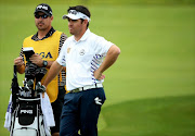 Louis Oosthuizen of South Africa waits alongside caddie Wynand Stander during the first round of the 96th PGA Championship at Valhalla Golf Club on August 7, 2014 in Louisville, Kentucky.