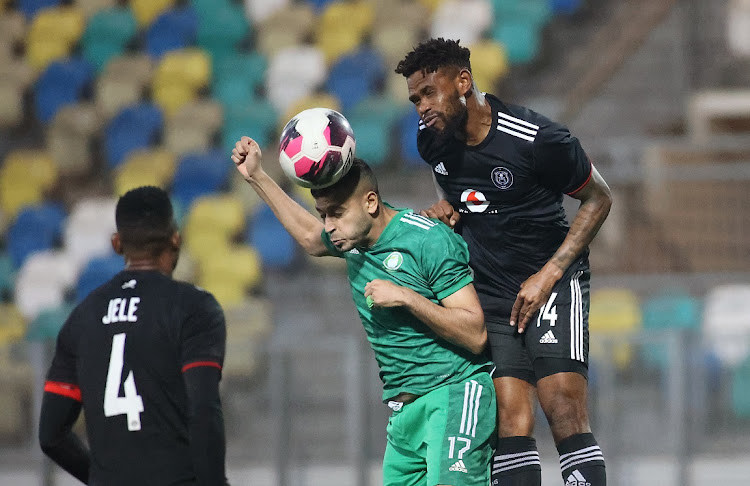 Muetaz Husayn of Al Ahli Tripoli beats Thulani Hlatshwayo of Orlando Pirates to a header in the Caf Confederation semifinal first leg match at the Martyrs of February Stadium in Benghazi, Libya on May 8 2022.