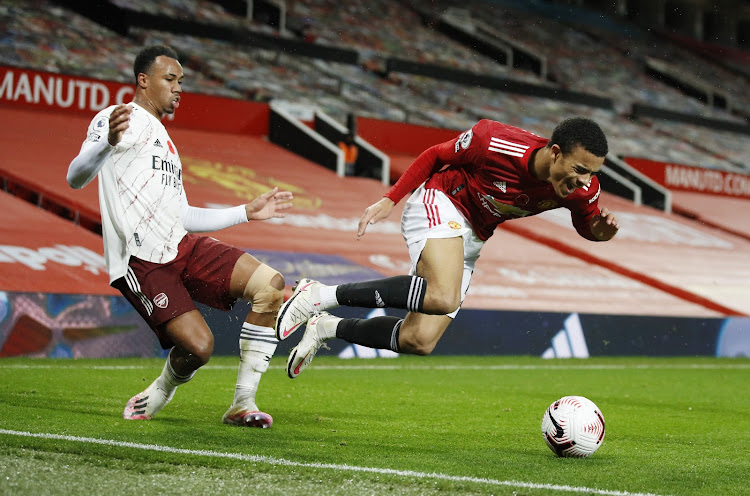 Manchester United's Mason Greenwood in action with Arsenal's Gabriel Magalhaes