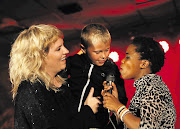 Afrikaans rocker Karen Zoid and Zolani Mahola from Freshlyground sing with Charl Hess, 7 , during the Klein Karoo National Arts Festival in Oudtshoorn in the Western Cape