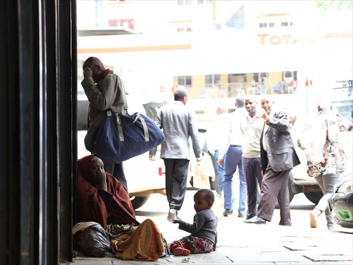 Two women and their children beg along Kimathi street April 10,2017.In the recent past,there has been an influx of street families within the central business district.Photo/HEZRON NJOROGE