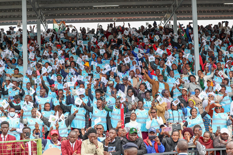 County health workers waving at President William Ruto inside the Kericho Stadium during Mashujaa Day celebrations on October 20, 2023