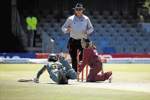 UNDER PRESSURE: South Africa's Trisha Chetty diving to get back into her crease as West Indies’ Anisa Mohammed goes for the run-out at Buffalo Park in East London yesterday Picture: MARK ANDREWS