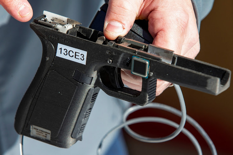 Rob Regent of SGW Designworks breaks down the inner working of the 9mm smart gun, which works only for the designated user, during a presentation for shareholders and potential investors in Boise, Idaho, US, on January 7 2022. Picture REUTERS/BRIAN LOSNESS