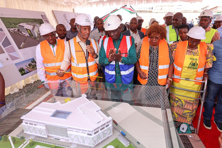 President William Ruto being shown lay out of Eldoret 64 Ultra-Market during its construction launch on January 9, 2023