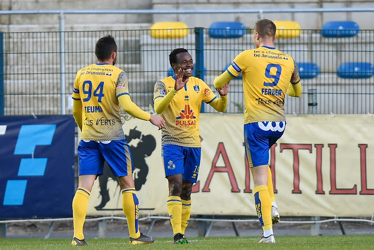 Percy Tau (C) celebrates a goal with his teammates on May 12.