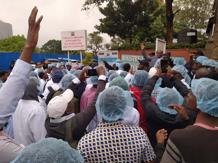Medical interns protest outside Afya House over failure by the Ministry of Health to pay them their dues dating back to January