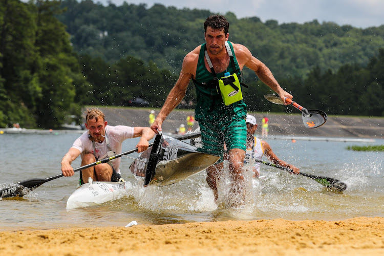 Andy Birkett leads the front bunch into a portage en route to winning the gold medal in the men's marathon final at the Oak Mountain State Park at the World Games on Tuesday. Picture: IFC/BALINT VEKASSY