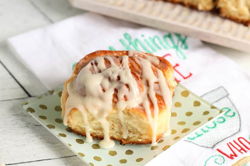 Icing Drizzled Over The Cinnamon Rolls.