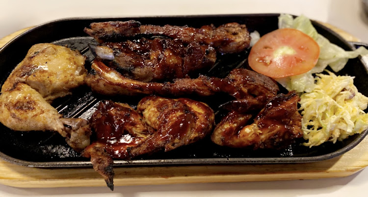 A platter of mixed high protein meal served with a side of coleslaw