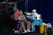 A women does a NAT test in the area of Fai Chi Kei after a resident tested positive to Covid-19 in Macau, on Thursday, October 27, 2022.