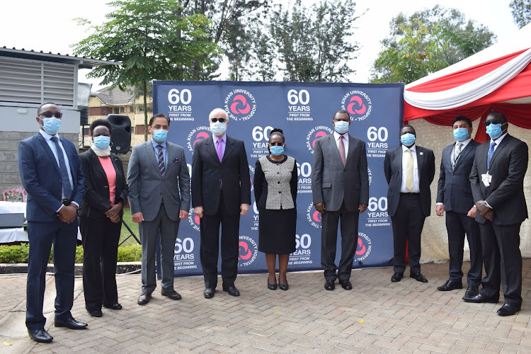 Members of the hospital’s senior management team pose for a photo with Muturi