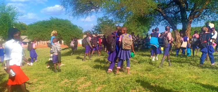 Gai Primary School parents in Kyuso take their children home.