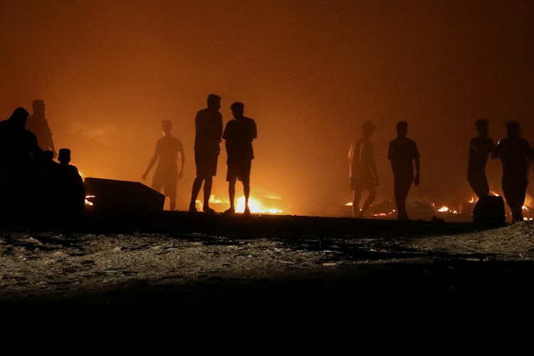 Demonstrators burn tires in protest against the meeting which was held last week in Italy between foreign affairs ministers of Libya and Israel, in Tripoli, Libya, August 27, 2023.