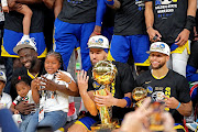 Golden State Warriors forward Draymond Green (23), guard Klay Thompson (11) and guard Stephen Curry (30) celebrate after beating the Boston Celtics in game six of the 2022 NBA Finals to win the NBA Championship at TD Garden. 