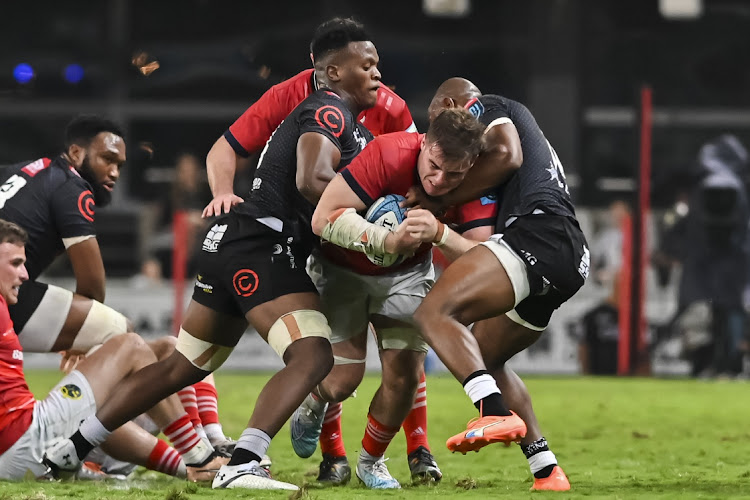 Alex Kendellen of Munster is tackled during the United Rugby Championship match against the Sharks at Kings Park.