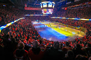 Ukrainian flags are displayed during Ukraine national anthem performed by Stephania Romaniuk prior to the game between the Calgary Flames and the Edmonton Oilers at Scotiabank Saddledome.  