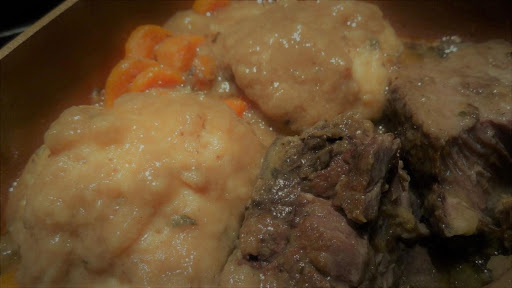 Beef short ribs with beef gravy and dumplings.