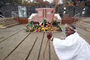 John Mhlongo seen praying at the Hector Pieterson memorial site in Soweto.