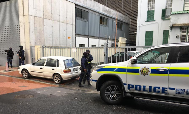 Tactical response officers stand guard as drugs worth R3m - allegedly peddled by Fadwaan Murphy - are brought to the Cape Town high court on August 8 2019.