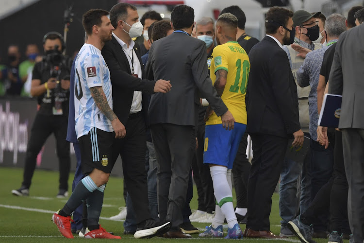 Argentina's Lionel Messi (L) and Brazil's Neymar are seen after employees of the National Health Surveillance Agency (Anvisa) entered to the field during the South American qualification football match for the FIFA World Cup Qatar 2022.