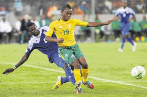 RIDING THE CHALLENGE: Salif Kèita of Central African Republic tackles May Mahlangu of South Africa during their Fifa 2014 World Cup qualifier at Cape Town Stadium on March 23 Photo: Gallo Images