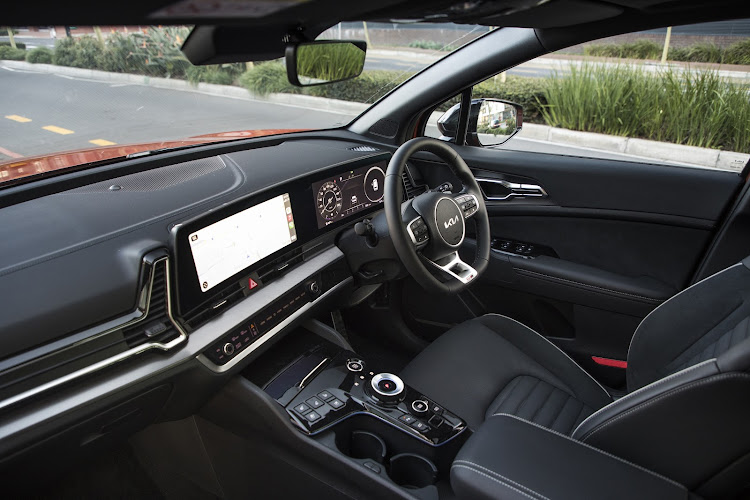 The premium interior features a curved display.