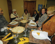 Overseas visitors dine with locals. 