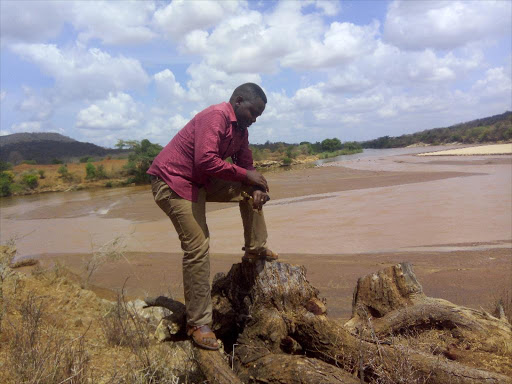 A man at the proposed site of Thwake Multipurpose Dam where Rivers Thwake and Athi meet in Makueni county