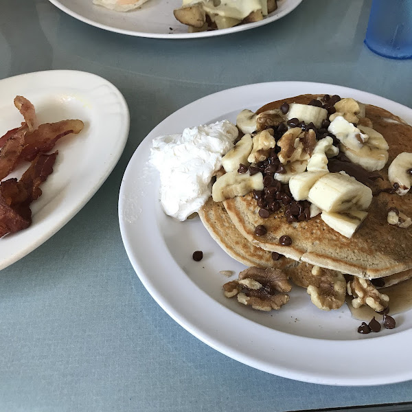 Gluten free pancakes with Chunky Monkey topping and a side of bacon.