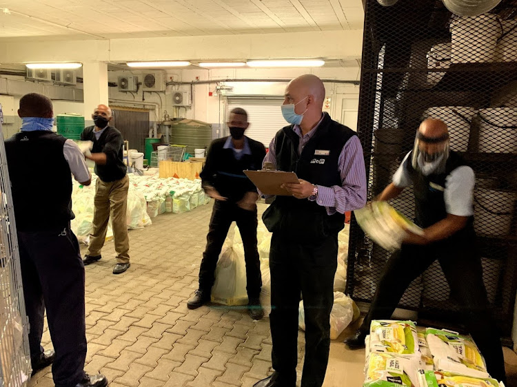 The Courage team prepares food parcels for delivery families as part of their efforts to feed 60,000 people in Hout Bay during lockdown.