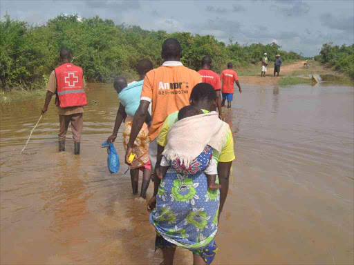 Red Cross officials rescue Vitengeni residents after heavy rains in Kwale county, November 17 2015. /ALPHONCE GARI