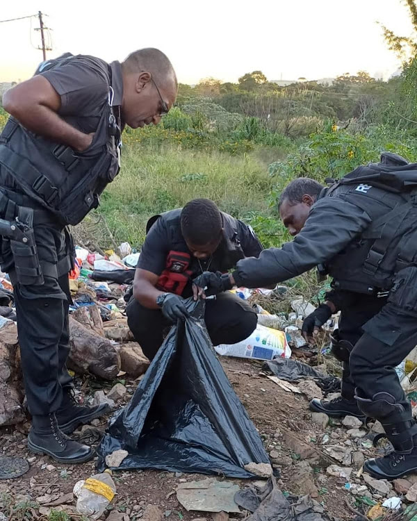 Reaction Unit SA officers inspect the foetus discarded at a dump site near Tongaat
