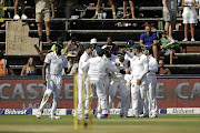 JP Duminy is congratulated by his teammates after he caught batsman Upul Tharanga (not pictured) during the third day of the third test against
Sri Lanka at the Wanderers in Johannesburg yesterday.