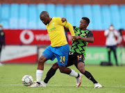 Sibusiso Vlakazi of Mamelodi Sundowns challenged by Steve Ehebelo of Maniema Union during the 2021 CAF Champions League match between Mamelodi Sundowns and Maniema Union.