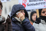 A participant cries as people protest in solidarity with the ongoing demonstrations in Iran and against the Islamic Republic's regime in front of the Brandenburg Gate on December 10 2022 in Berlin, Germany. 