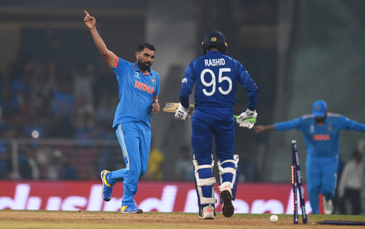 Mohammed Shami of India celebrates the wicket of Adil Rashid of England during their Cricket World Cup match at BRSABVE Cricket Stadium in Lucknow, India.