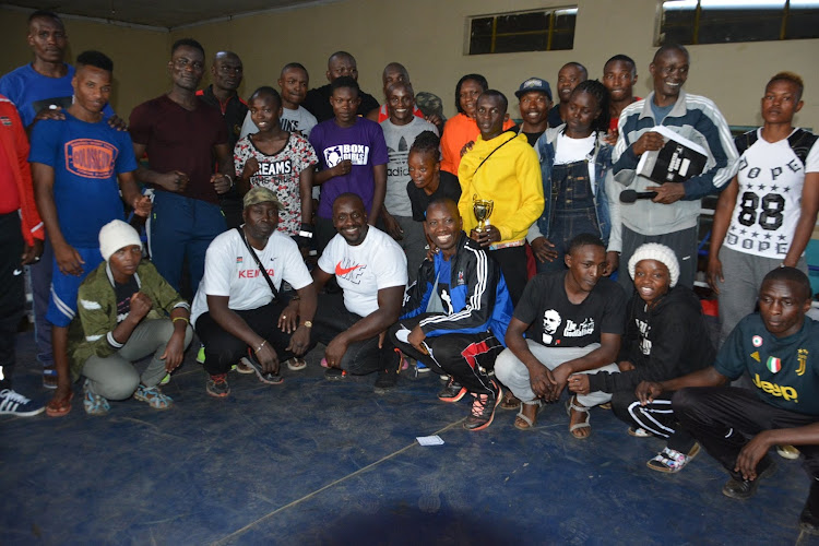 Provisional Kenya national boxing team squad pose for a group photo with BFK President Anthony Otieno(Kneeling,white t-shirt).