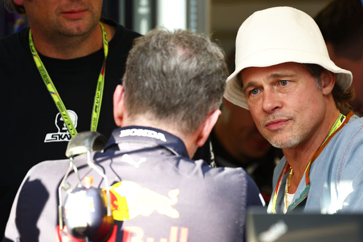 Brad Pitt talks with Red Bull Racing Team Principal Christian Horner in the Paddock during practice ahead of the F1 Grand Prix of USA at Circuit of The Americas on October 21, 2022 in Austin, Texas.