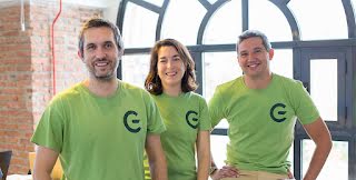 The GreeMko cofounders are wearing matching green shirts with their startups’ logo and smiling at the camera.