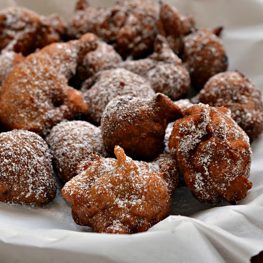 These Banana Fritters are family friendly super easy crispy fried fritters full of fresh banana, cinnamon, cloves and a pinch of allspice.  For a nice finishing touch dip in fresh maple syrup, sprinkle with powdered sugar or roll in cinnamon sugar.